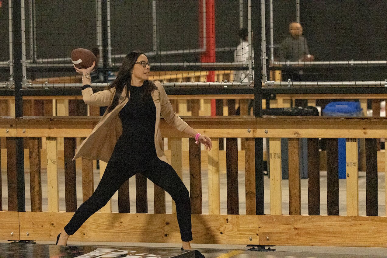 A person fowls at the Ypsi-Ann Arbor Fowling Warehouse. The sport of fowling involves using a football to knock down bowling pins.
