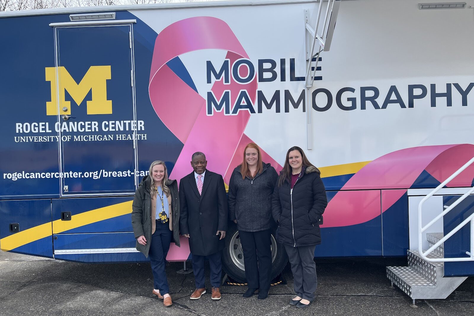 Laura Braid, Tony Denton, Lauren Esch, and Rebecca Hall with the new mobile mammography unit at the University of Michigan Ypsilanti Health Center.