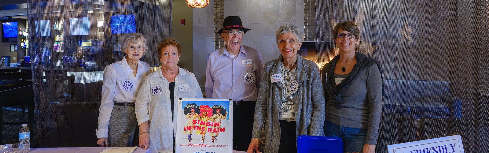 Jim Mangi (center) with volunteers at a dementia-friendly screening of "Singin' in the Rain" at Emagine Saline.