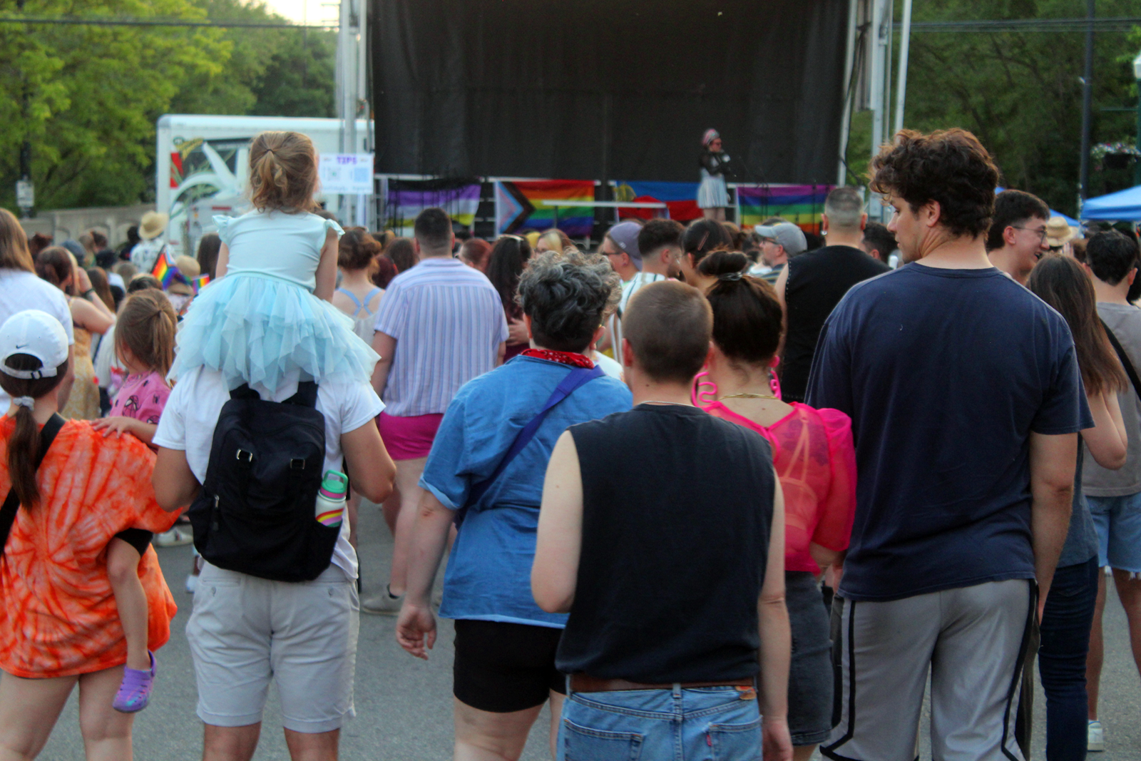 Cross Street stage host and Heads Over Heels Drag & Variety Shows host Zooey Gaychanel thanks the crowd for coming to Ypsi Pride before snapping photos of the audience.