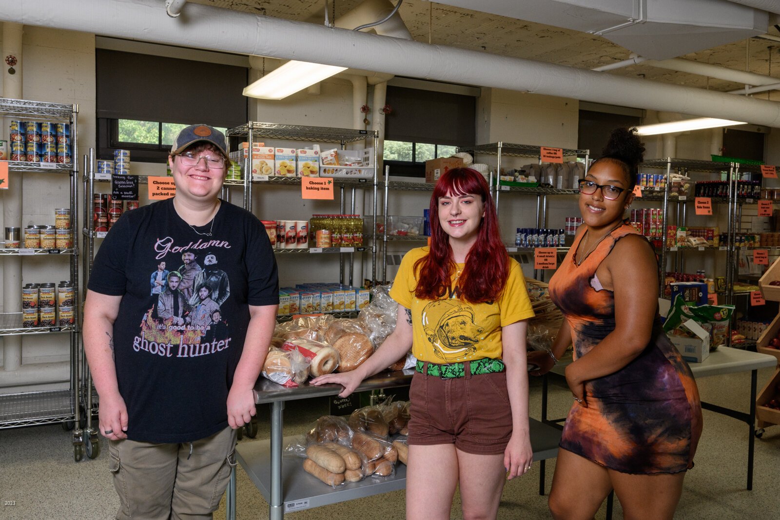 EMU students Ren Lands, Lauren Masserant, and Ruth Mella work at Swoop's Food Pantry.