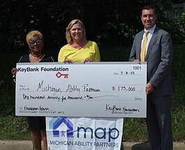 Michigan Ability Partners staff receive their grant from KeyBank.