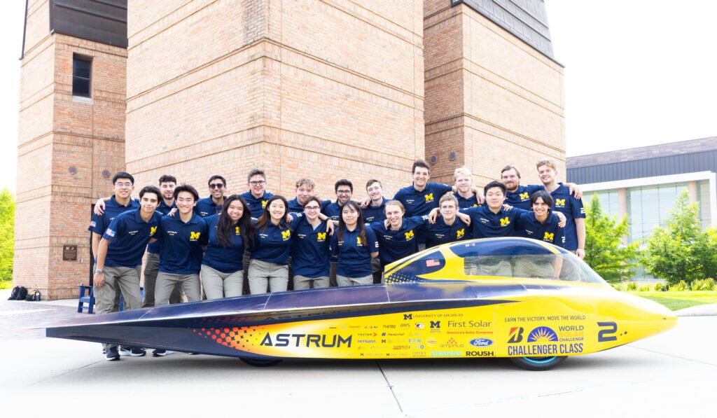 The entire Michigan Solar Car race crew with its 2023 vehicle, Astrum, on the University of Michigan’s North Campus.