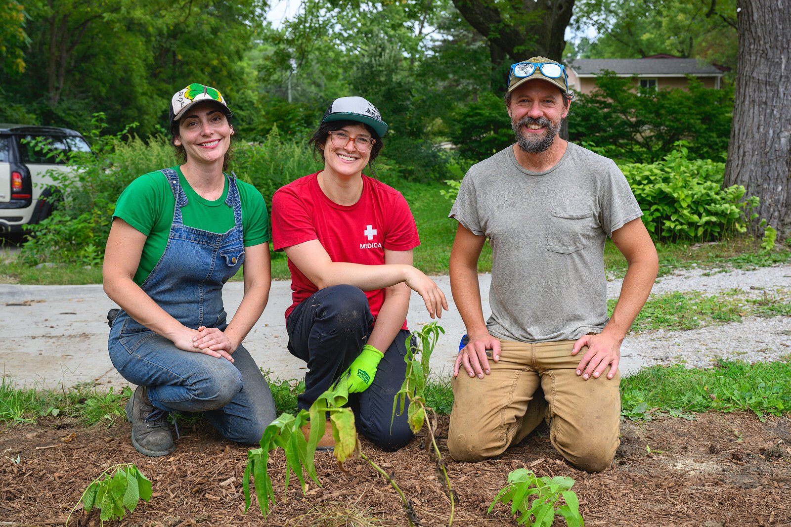 Kat Baskin, Rachel Lipson, and William Kirst of Adapt Landscapes planting a garden in Ann Arbor.