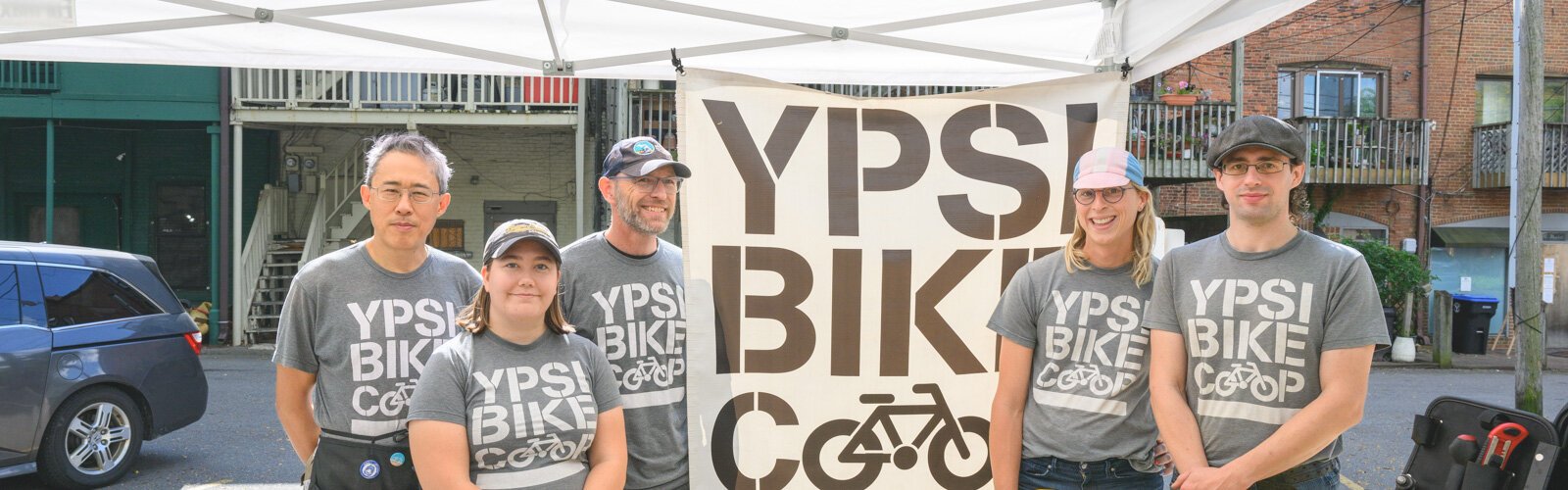  Yitah Wu, Emma Nelson, Terry Carpenter, Valerie Fox, and Anthony Lutz at the Ypsi Bike Co-op's booth at Ypsilanti's Depot Town farmers market.