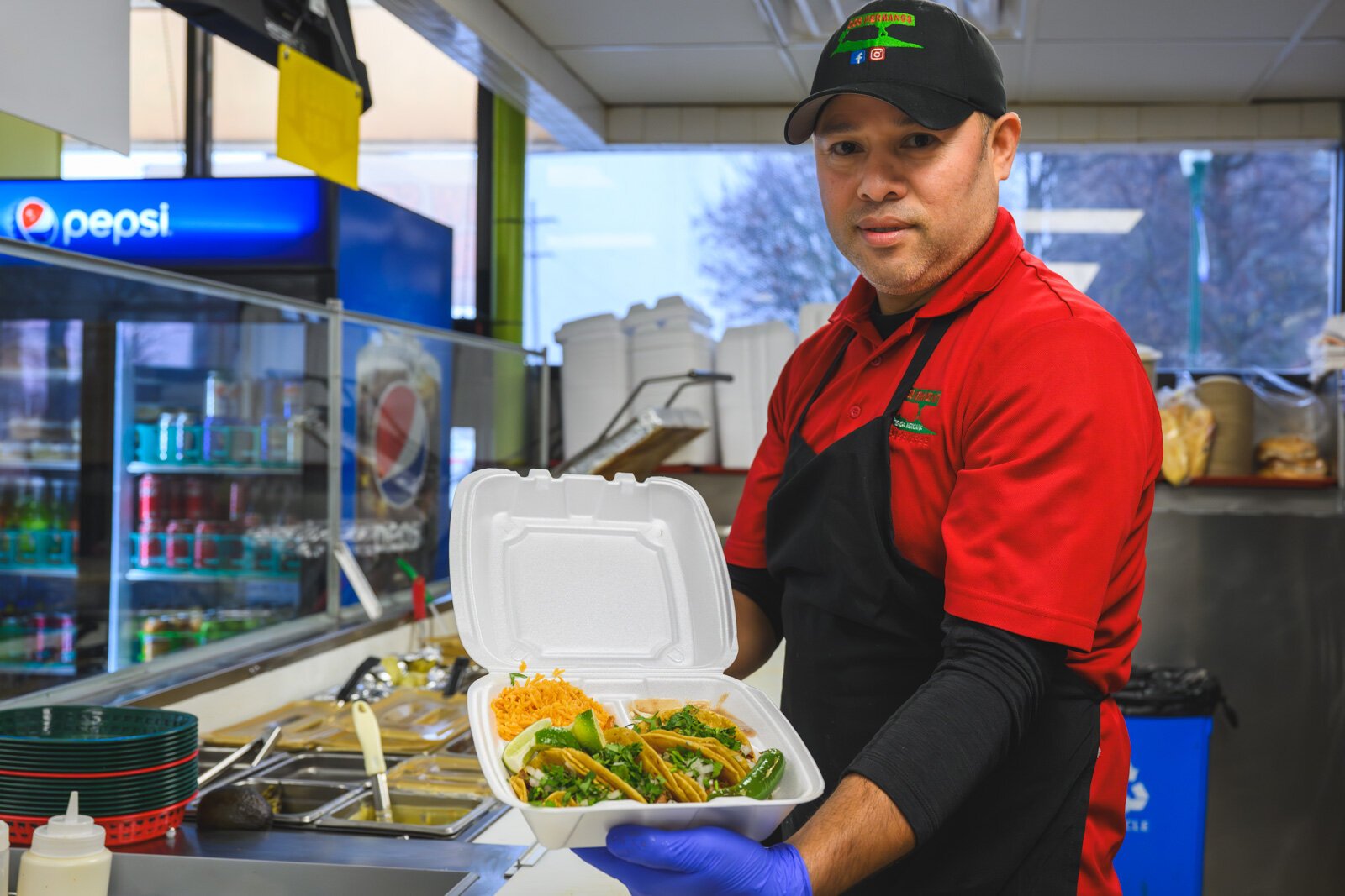 Reyes Arreola with a taco plate at Dos Hermanos Mexican Grill.