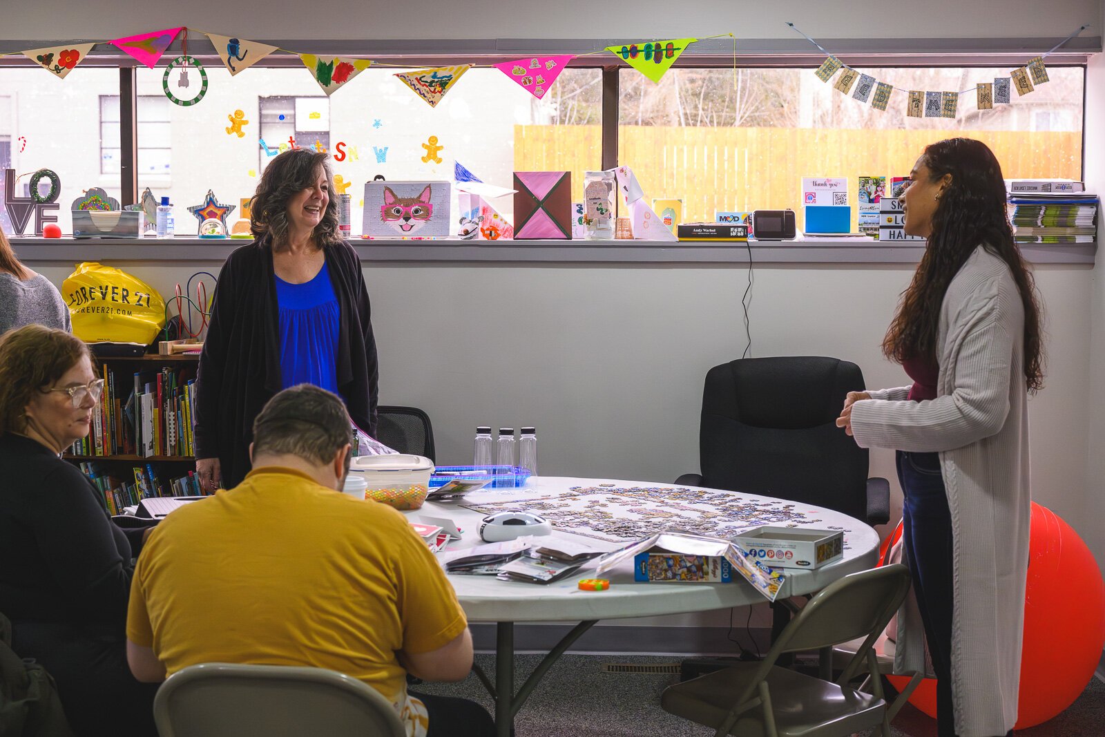 Zee Kennedy (right) at Feed The Need Sensory Zone at Unique Care Connect Community Center.