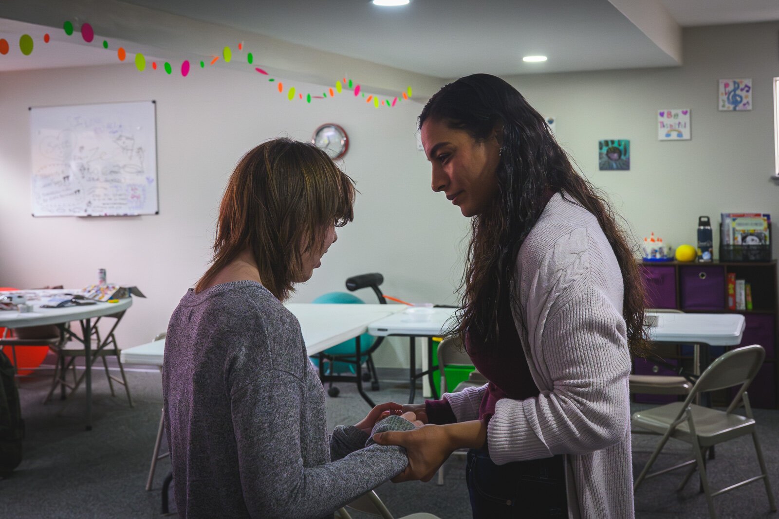 Zee Kennedy (right) at Feed The Need Sensory Zone at Unique Care Connect Community Center.