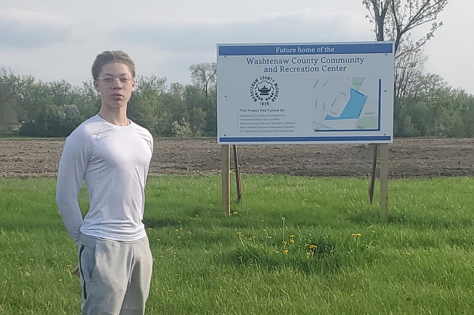 Author Jahshua Treadwell stands at the site of a future community center in Superior Township.