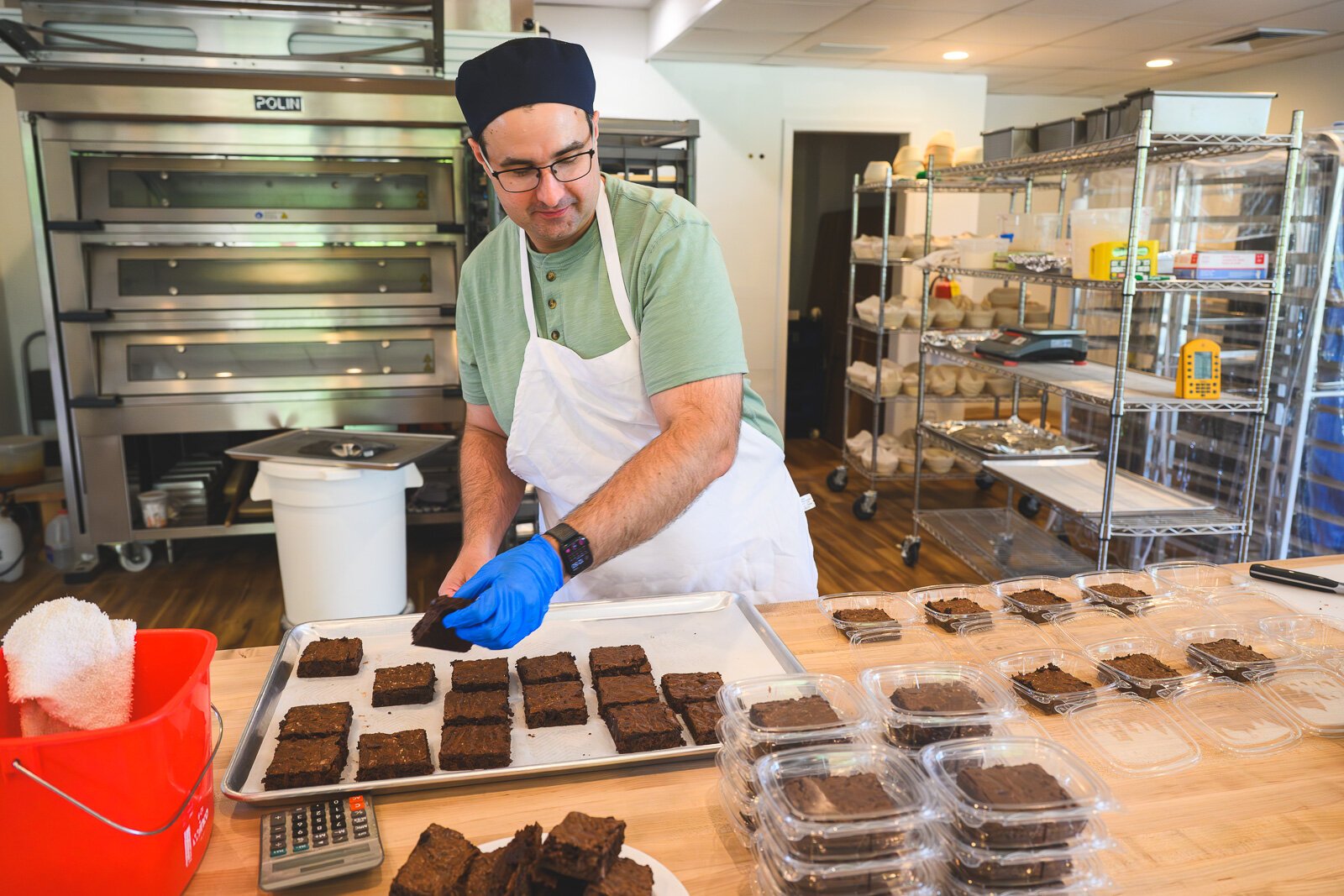 B-Cubed Bakery owner Bemjamin Brown packaging brownies for sale.