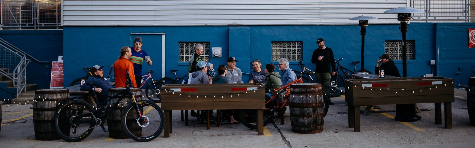 Members of the cycling group Spoke Junkies gather outside River's Edge Brewing Company in Milford after their bi-weekly ride.