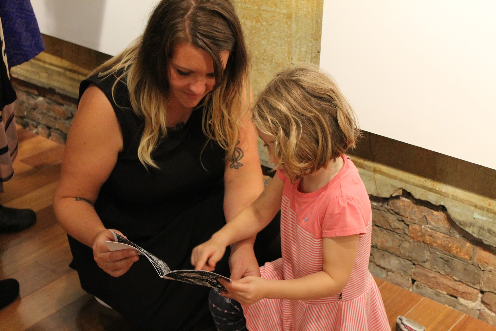Artist Corryn Jackson looking at zines with a 2015 Zine Show attendee.