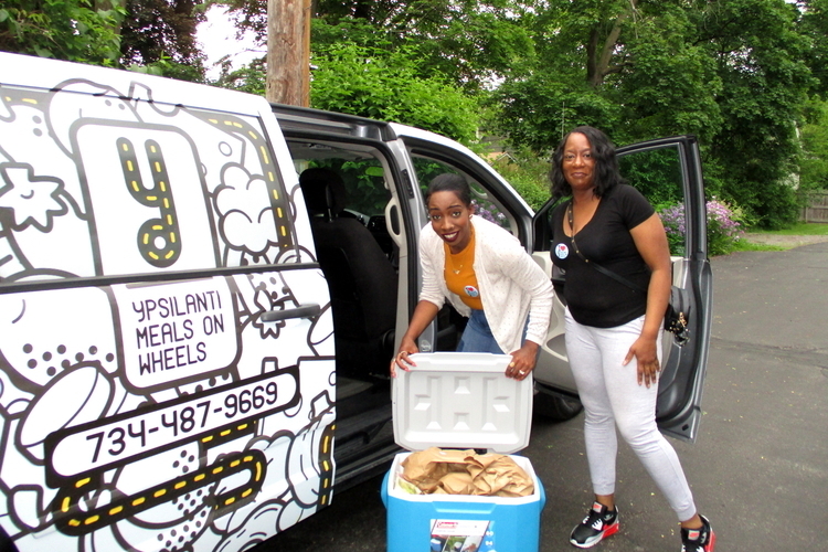 Staff drivers Ola Ibrahim and Traci Bibins load a van for YMOW's first Saturday delivery in 14 years.