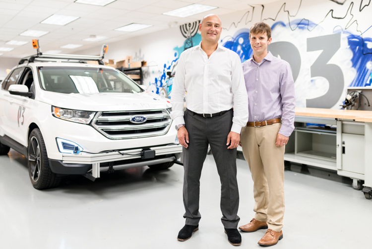 Samit Ghosh and Colin Goldsmith of P3 show off the ADAPT vehicle used to test autonomous technologies.