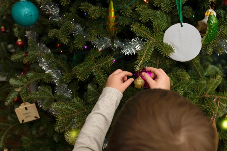 The Rudy family decorates their Christmas tree. Photo by Sally Rudy Photography.