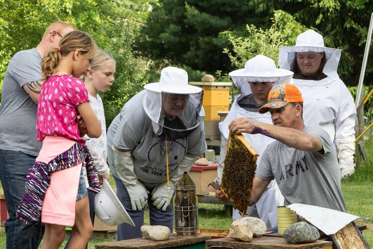 Karl Geiger teaches a group of 4H youth in the BEElievers program, and their parents, about bees.