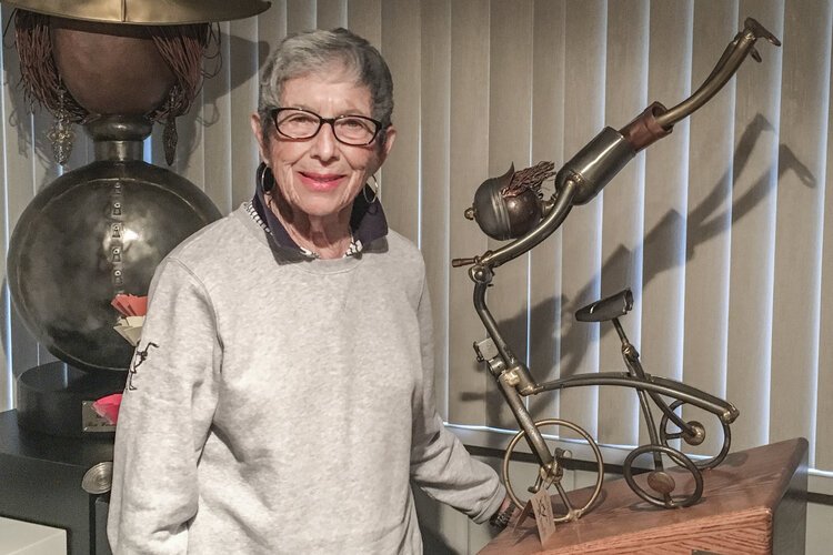 Rose Wunderbaum Traines stands with one of her metal sculptures – one which won an award in New York at the Salmagundi Club. 