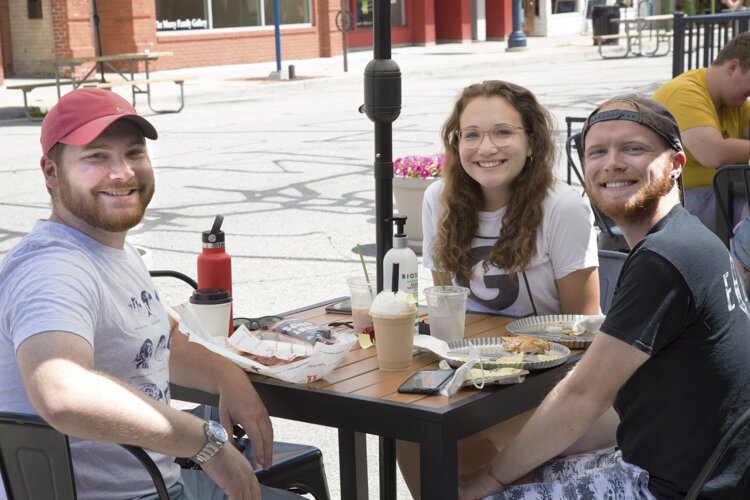 Andrew Strzycewski (left), Jennifer Gladkowski, and Joseph Haynes enjoy lunch from the downtown restaurants on Monday, July 20. 