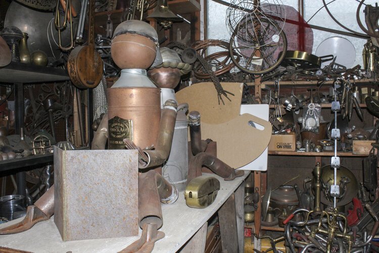 A work-in-progress sculpture of children reading sits in Rose Wunderbaum Traines’ garage.