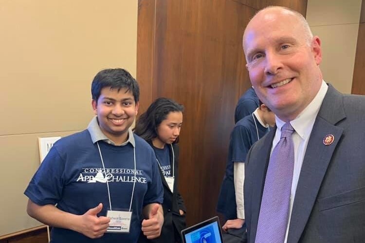 Ashwin Saxena, the winner of the The Congressional App Challenge for the Fourth District in 2018, poses with Rep. John Moolenaar.