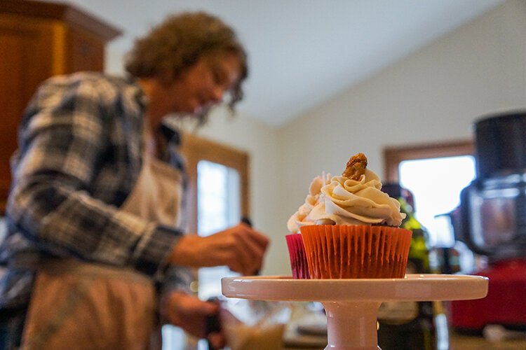 Kim Brown displays her cupcakes on her kitchen counter while she mixes ingredients for other baked goods.
