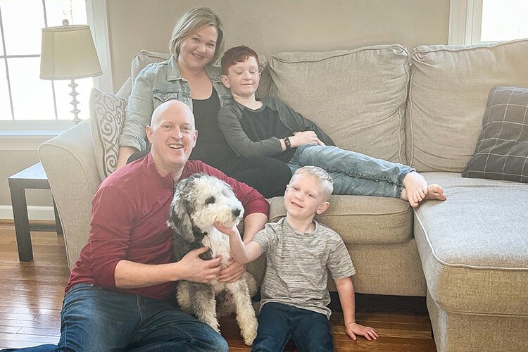 Beth and Matthew Binder with their two sons, Owen (8) and Gavin (5), as well as their bernedoodle puppy, Murphy. 