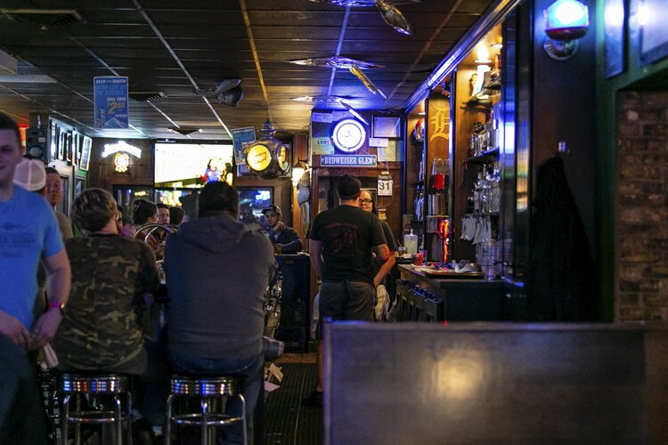 Manager DJ Blizzard speaks with an employee at The Bird Bar and Grill.