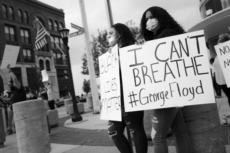 Many of the signs carried by participants in Bay City's protest mentioned George Floyd, the African American man who died May 25 after being restrained by a Minneapolis police officer.