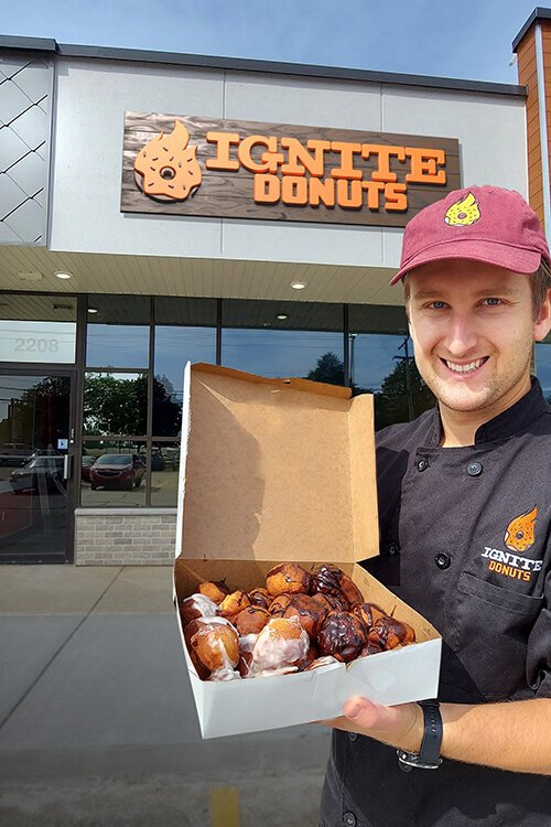 Casey Croad, Founder and CEO of Ignite Donuts, stands outside the new café located at 2208 S. Mission St. in Mt. Pleasant, Michigan.