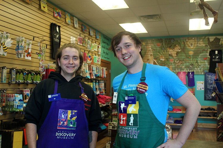 Mt. Pleasant Discovery Museum staff members Eli (left) and Isaac pose for a photo wearing their game day pins.