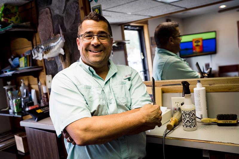 Second generation barber Bill Cook inside Bob's Barbershop