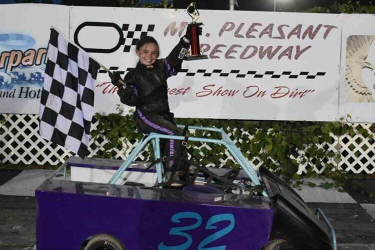 Ella Bringer poses with her trophy and car after a race.