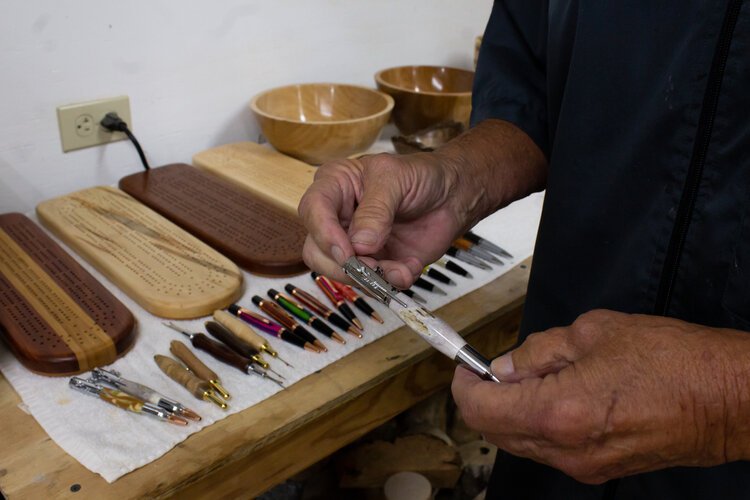Frank Tiahrt demonstrates how one of his hand-crafted pens works.