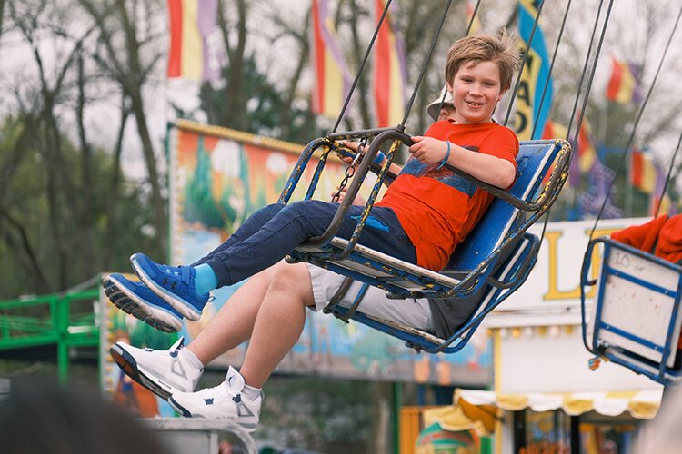 Festival goers partake in the Midway Carnival at the 2023 Maple Syrup Festival in Shepherd, MI on Saturday, April 29, 2023. (Dan Gaken/ Epicenter)