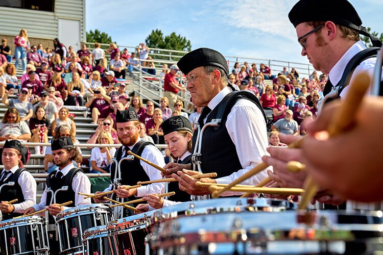 Dave Zerbe, Kiltie Marching Band director, plays the percussion with team members at Alma College.