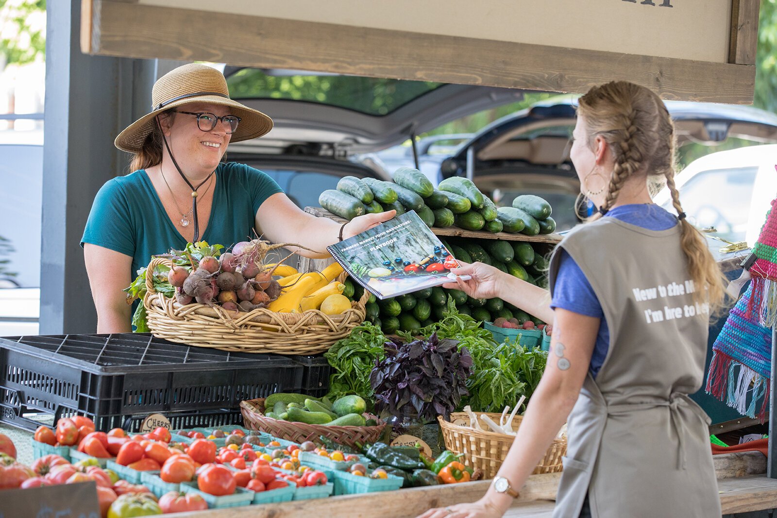 A Farmers Market Food Navigator interacts with a market patron.