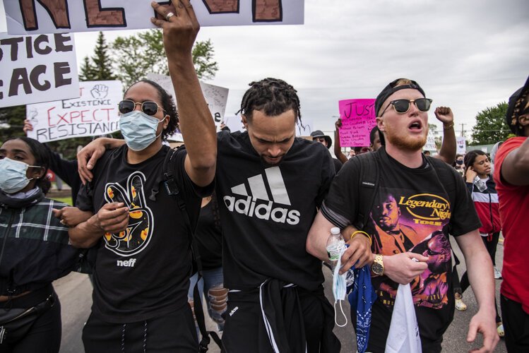 (From left to right) Gil Melvin, Rondo Sanders and Steven Green march toward downtown Mount Pleasant during an event to protest the death of George Floyd and social injustice June 1 on Mission Street in Mount Pleasant, MI.