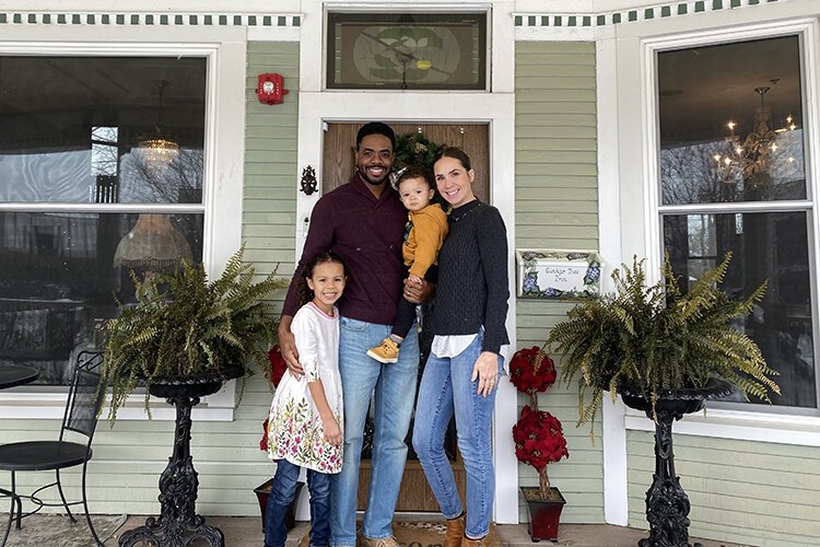 David and Layla Davis pose with their two children, Olivia and Liam, in front of the Gingko Tree Inn.