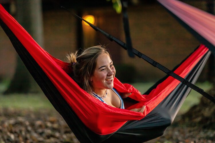 Lily Lemke, 19, of Indiana, laughs with a group of four friends in individual hammocks on Central Michigan University’s campus. 