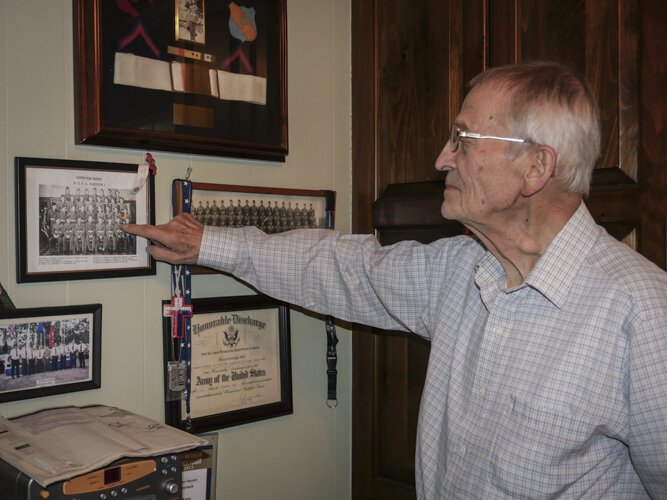 Ed Haynack points out himself in a photo from his military service.