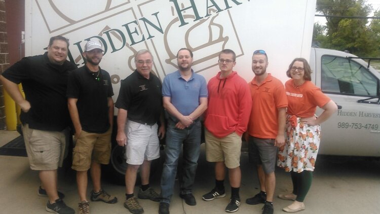 Samantha McKenzie, Hidden Harvest President and CEO, at far right, has leads a team of employees and volunteers dedicated to ending food waste and hunger in this area.