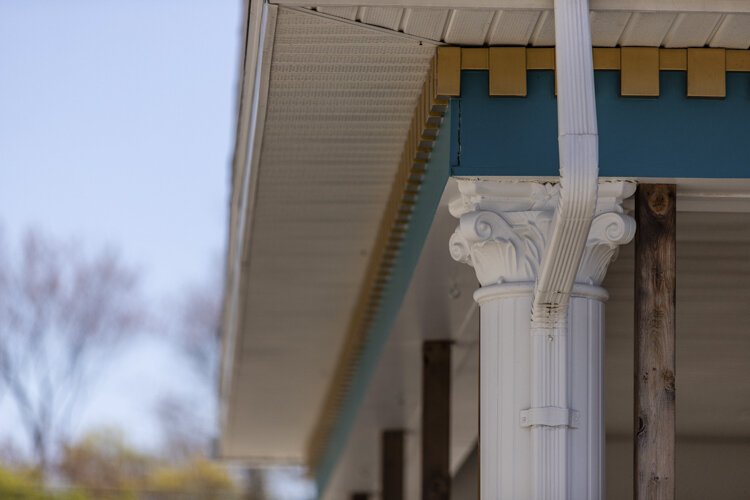 Columns and decorative molding line the back porch of 503 East Broadway.
