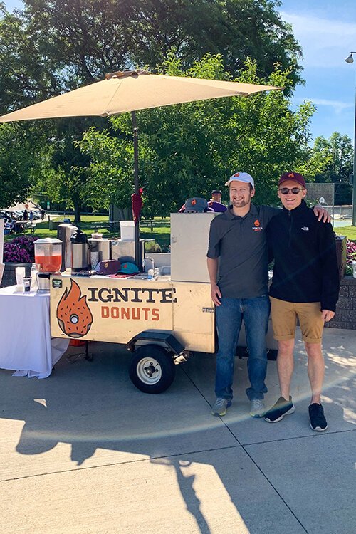 Casey Croad (left), Founder and CEO of Ignite Donuts, poses for a photo with Cole Essenberg.