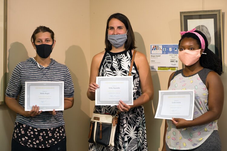 First place Chalk the Walk winner Malia Reger (left) and second place winners Erika Squanda (middle) and Leah Coicou pose for a photo at Art Reach of Mid Michigan on Saturday, Aug. 15, 2020.