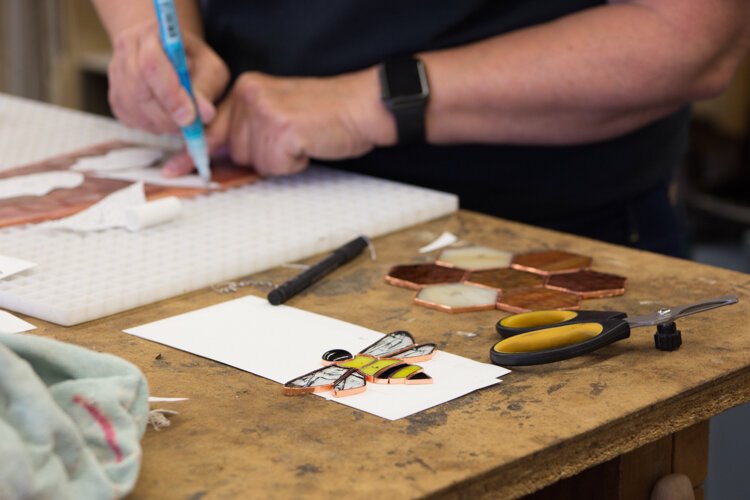 Creatively! Glass & More glass artist Sharon Holzhausen works on a stained glass art piece.