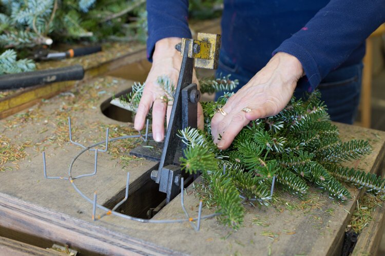 Laura Allen, owner of Vander Sys Tree Farm Nursery, creates a wreath.