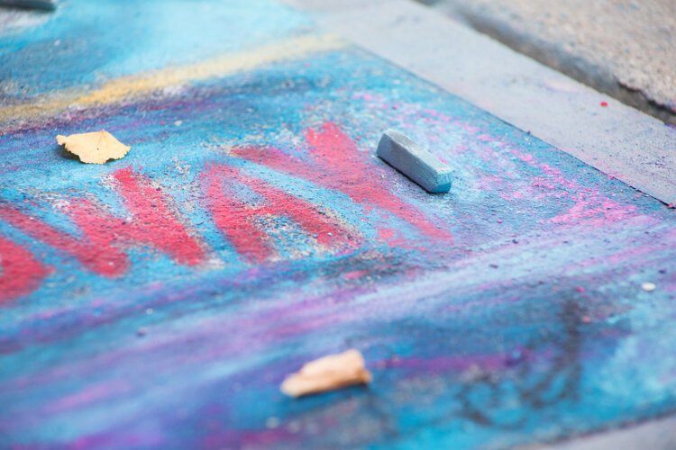 Chalk the Walk artists used pastels instead of traditional sidewalk chalk because pastels are more vibrant and weather-resistant.