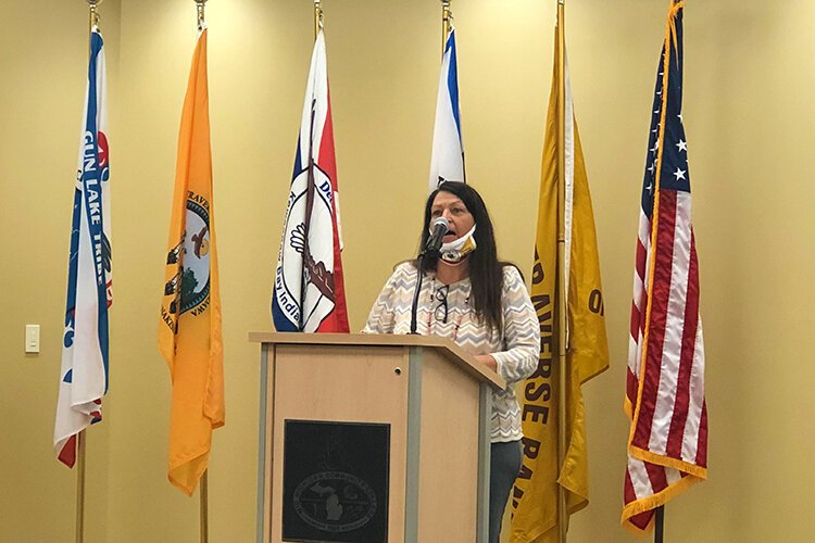 A Saginaw Chippewa Indian Tribe Elder leads the audience in prayer at the start of the Honoring Indigenous People's Day event.