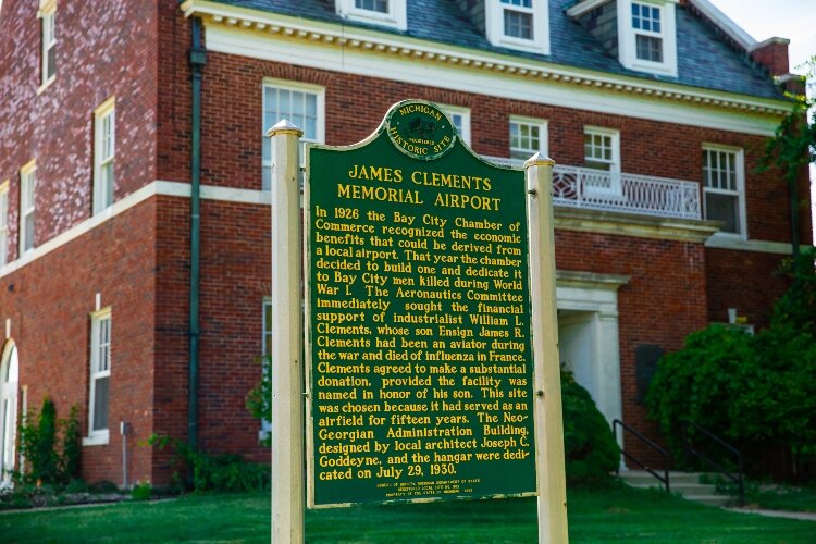 A plaque explains the history of the airport and Administration Building. A hangar and the administration building were dedicated in 1930.