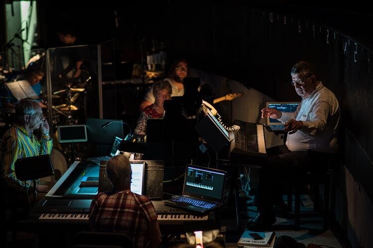 Crew members backstage during a show of Mamma Mia!